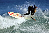 Surfing at St Clair Beach, Dunedin, New Zealand.