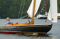 Keelboat sailing during Wroxham Open Regatta Week, Wroxham Broads, Norfolk, England, UK.