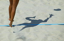 Legs and shadow of a player during the Germany versus Bulgaria beach volleyball match, Olympic Games, Athens, Greece, 16 August 2004.  Editorial Use Only.