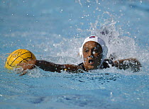 Player goes for the ball in a water polo match at the Athens Olympics 2004.