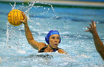 A player takes on her opponent at a women's water polo match, Olympic Games 2004, Athens, Greece.  Editorial Use Only.