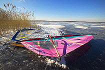Freeskater on Worden Pond, Rhode Island, USA. ^^^ Freeskaters are similar to skateboards but with ice blades instead of wheels, and are propelled using a windsurf sail.
