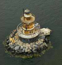 The Plum Beach Lighthouse, built in 1899, in disrepair before renovations, near Newport, Rhode Island, USA.