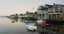 Waterfront houses with small boats tied up in front, Nantucket, USA.