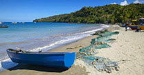 Fishing net and rowing boat on Gouyave beach, Grenada, Caribbean.