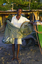 Gouyave fisherman with his net and catch, Grenada, Caribbean.