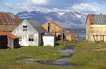 Buildings at the abandoned whaling station in Grytviken with mountains beyond, South Georgia.