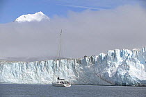 Beneath the low lying cloud, the 88ft sloop "Shaman" approaches the Nordenskjold Glacier in Cumberland Bay, South Georgia.
