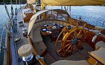 Cockpit of a 105ft Bruce King ketch "Whitehawk" with the table set for dinner, anchored in Mackerel Cove, Rhode Island, USA.