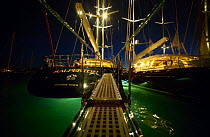 Superyachts lit up at night in Gustavia during the St Barts Bucket, Saint Barthelemy, Caribbean.