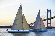 12m "Gleam" US11 and "Onawa" US6 sailing at sunset under the Neport Bridge, Rhode Island, USA. Property Released (both boats).