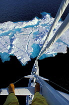 Looking down the mast of 88ft Sloop "Shaman" from about 100 ft with the feet of the photographer in view, Spitsbergen, Svalbard, Norway.
