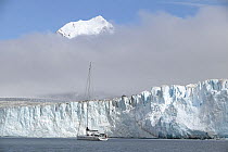 Beneath the low lying cloud, the 88ft yacht "Shaman" approaching the Nordenskjold Glacier in Cumberland Bay, South Georgia. Property Released.