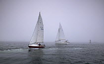 Navigating yachts in the fog on Narragansett Bay, Newport, Rhode Island, USA.