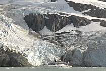 The 88ft sloop "Shaman" in Drygalski Fjord, at the south-eastern tip of South Georgia. ^^^The dramatic steep sided fjord flanked by the snow-covered jagged volcanic peaks of the Salvesen Range provide...