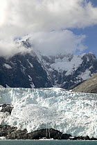 The 88ft sloop "Shaman" dwarfed by the glacier in Drygalski Fjord, at the south-eastern tip of South Georgia. Property Released. ^^^The dramatic steep sided fjord flanked by the snow-covered jagged vo...