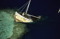 Trawler wrecked on a coral reef off the French island of New Caledonia, South Pacific.