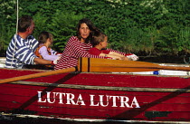 Young family aboard 'Lutra Lutra' (meaning Otter) rowing in the Great Glen Raid, Scotland. ^^^Rowing in the narrow stretches and sailing through the lochs, the Great Glen Raid competitors cross Scotla...