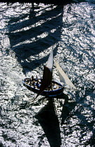 Restored oyster boat sailing in the shadow of a three masted square rigged tall ship in the big Brest gathering in Brittany, France.