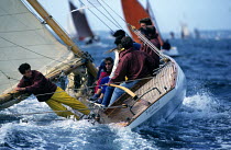 Crew getting wet while tying a reef on "Esterel" at the start of the Brest sailing rally. Brittany, France.
