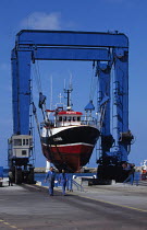 Fishing trawler hauled out on a travel hoist for annual maintenance. Lechiagat boatyard, South Brittany, France.