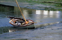 Boat at low tide on the Crach River, near the Golf du Morbihan, South Brittany, France.