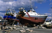 Two iron trawlers undergoing repairs at Le Guilvinec, Brittany, France.
