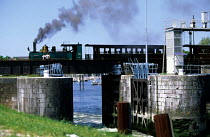 Old steam train passing over the lock of St Valery sur Somme, France.