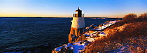 Castle Hill Light house surrounded by snow under a wintery sunset. Established in 1890, the lighthouse marks the East Passage into Narragansett Bay, near Newport, Rhode Island, USA.