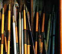 A pile of wooden oars stacked for winter storage, Maine, USA.