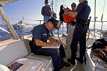 US Coastguard doing routine checks onboard a yacht off Boston, USA