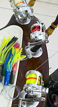Brightly coloured deep sea fishing lures and reels.