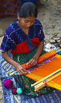 Woman weaving by hand, Guatemala.