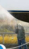 Pressure washing a cruising yacht at the end of the season.