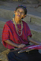 Local woman weaving using a traditional hand loom, Guatemala.