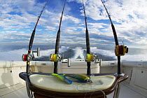 Heavy duty deep sea fishing reels lined up on the stern of a sport fishing boat, Guatemala.