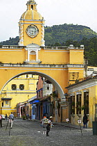 Old clock tower and colourful buildings on the cobbled streets of Antigua, Guatemala.