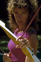Florence Arthaud modelling with a bow and arrow for Figaro magazine, at the Hotel Travel Lodge in Suva, Fiji. She is a French sailor and won the Route du Rhum 1990 aboard her trimaran "Pierre 1er".