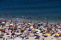 Sun bathers and swimmers on Ipanema Beach, Rio de Janeiro, Brazil.