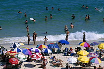Sun bathers and swimmers on Ipanema Beach, Rio de Janeiro, Brazil.