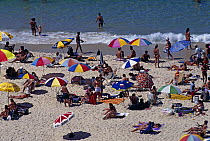 Sun bathers and paddlers on Ipanema Beach, Rio de Janeiro, Brazil.