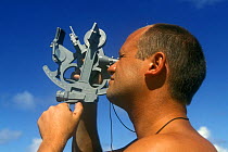 A man navigating by Sextant, a measuring instrument generally used to measure the angle of elevation of a celestial object above the horizon. Model Released. ^^^Making this measurement is known as sig...