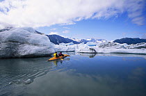 Kayaking among icebergs at the foot of Bear Glacier, Kenai Fjords National Park, Kenai Peninsula, Alaska.