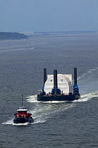 A tug towing a barge with secret navy equipment under cover, Narragansett Bay, Rhode Island, USA.
