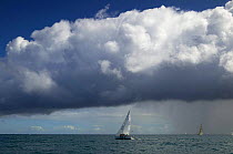 Dark clouds and a squall over racing yachts.