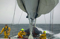 Crew of "Sariyah" working on the deck in strong onshore winds and a heavy swell, heading along the coast of Chile towards Cape Horn.