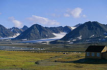 Mountains and glaciers with small cottages in the foreground, Longyearbyen, Spitsbergen, Svalbard, Norway.