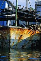 Rusty fishing trawler stored in a harbour, Cuba.