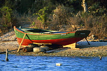 Wooden fishing boat on a pebble beach, Cuba.