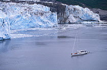 88ft sloop yacht "Shaman" anchored in front of a glacier, Kenai peninsula, Alaska.